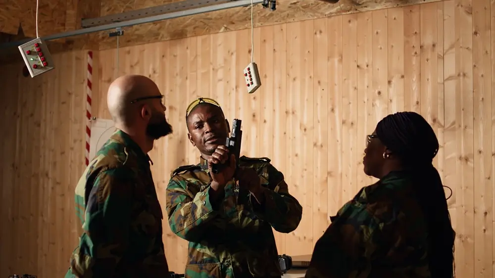 Un instructeur forme deux recrues militaires au maniement d'une arme de service lors de leur formation initiale.